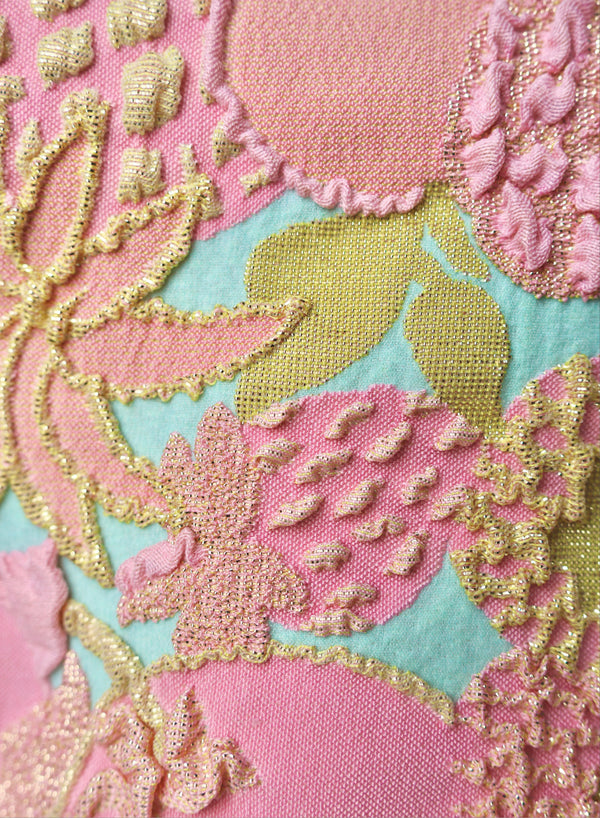 close up of pink, blue and gold jacquard swimsuit fabric texture
