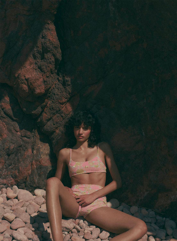 model is wearing pink floral bikini top swimsuit in jacquard fabric, with thin shoulder straps, front view