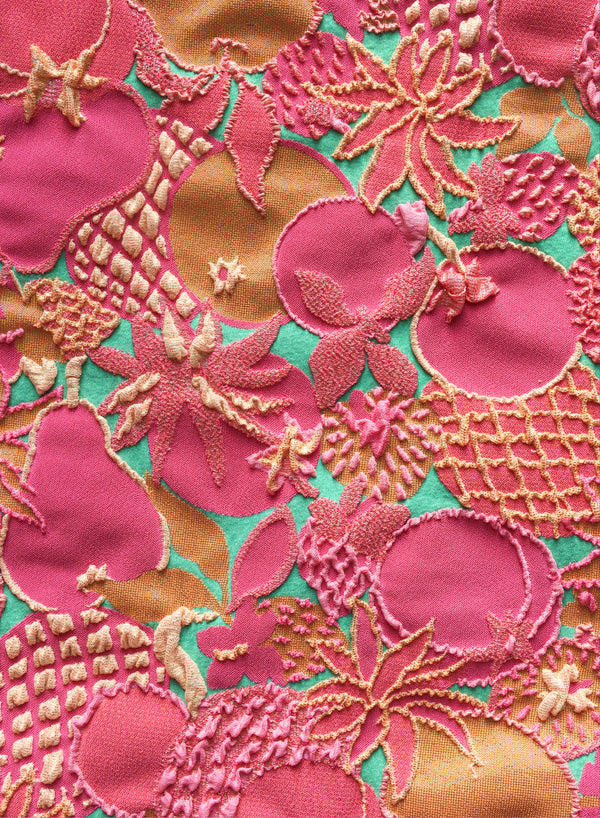 close up of pink, green and gold jacquard swimsuit fabric texture