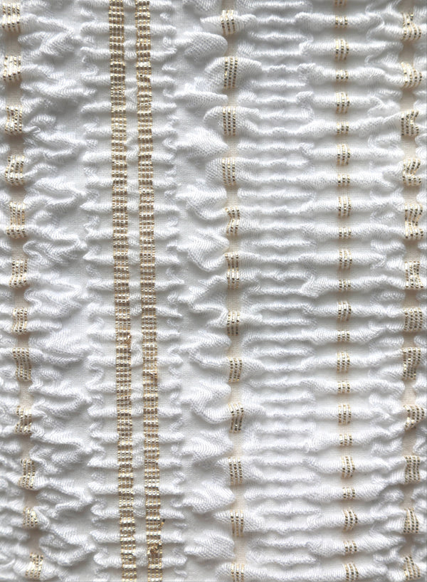 close up of white with gold jacquard  swimsuit fabric texture