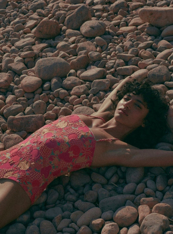 model is wearing dark pink floral one-piece swimsuit with square neckline and thin straps in a textured jacquard fabric, front view