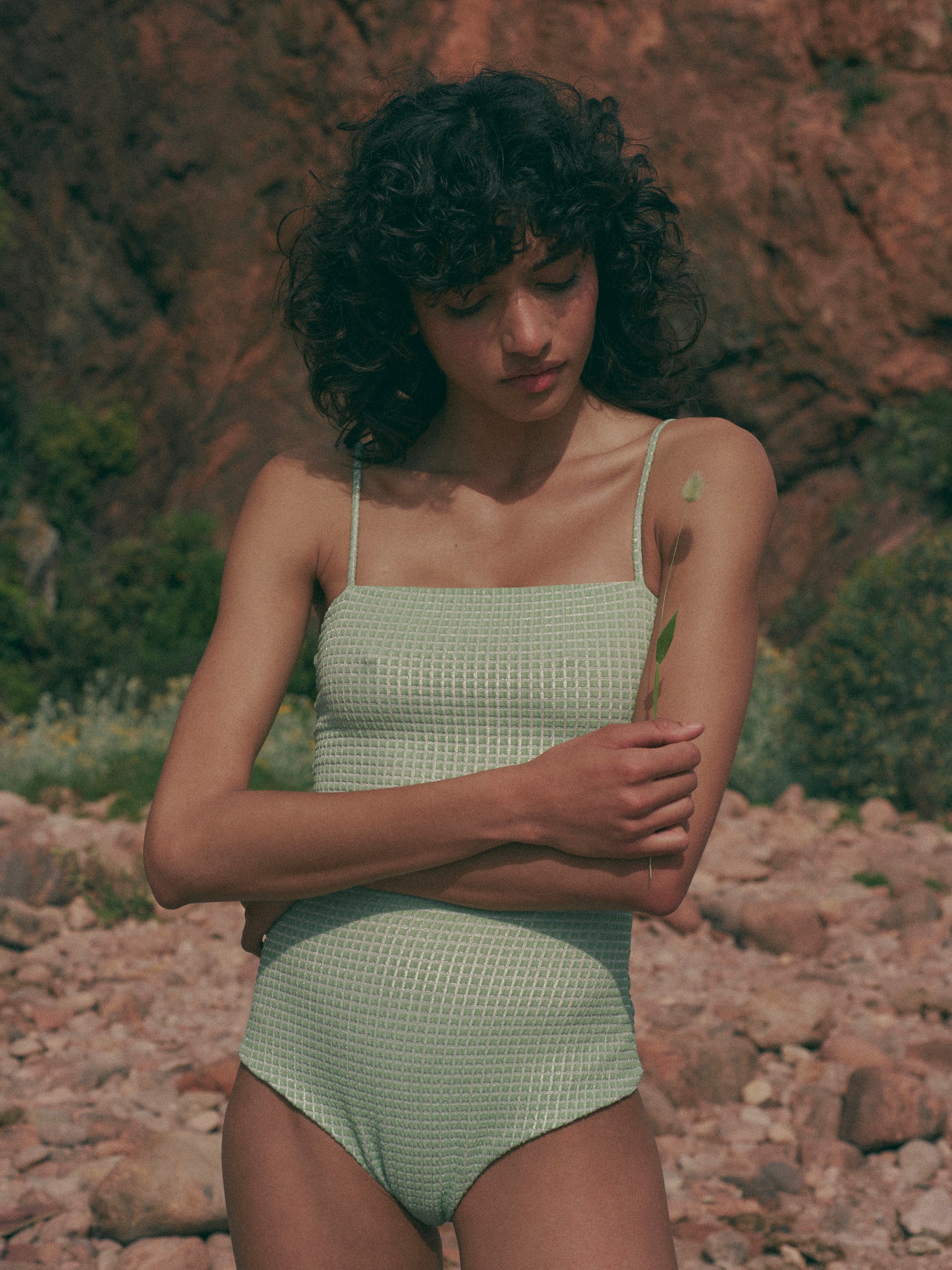 model is wearing green one-piece swimsuit with square neckline and thin straps in jacquard fabric, front view