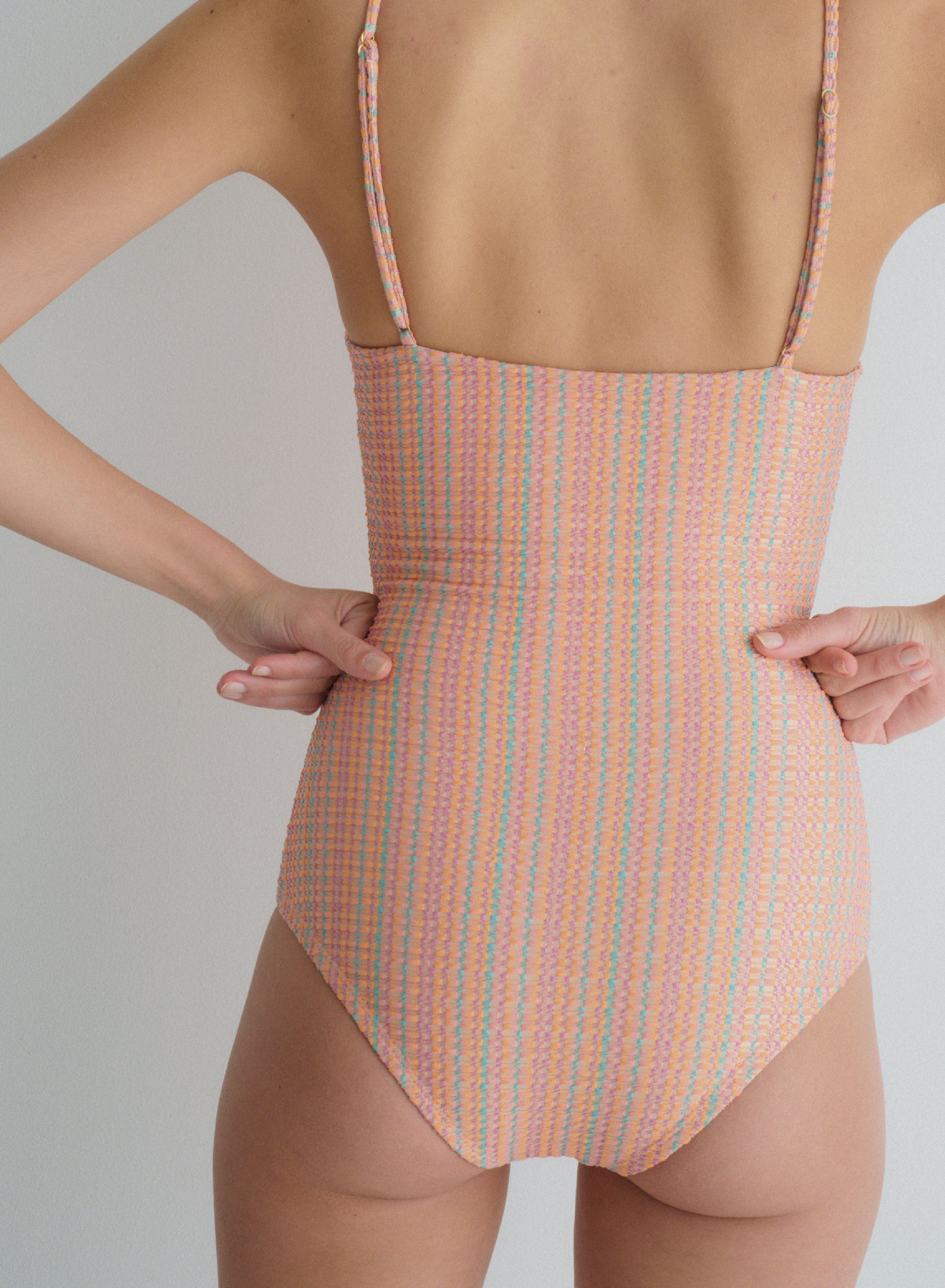 orange, multi color one-piece swimsuit with thin, adjustable shoulder straps in jacquard fabric,  full coverage, back view