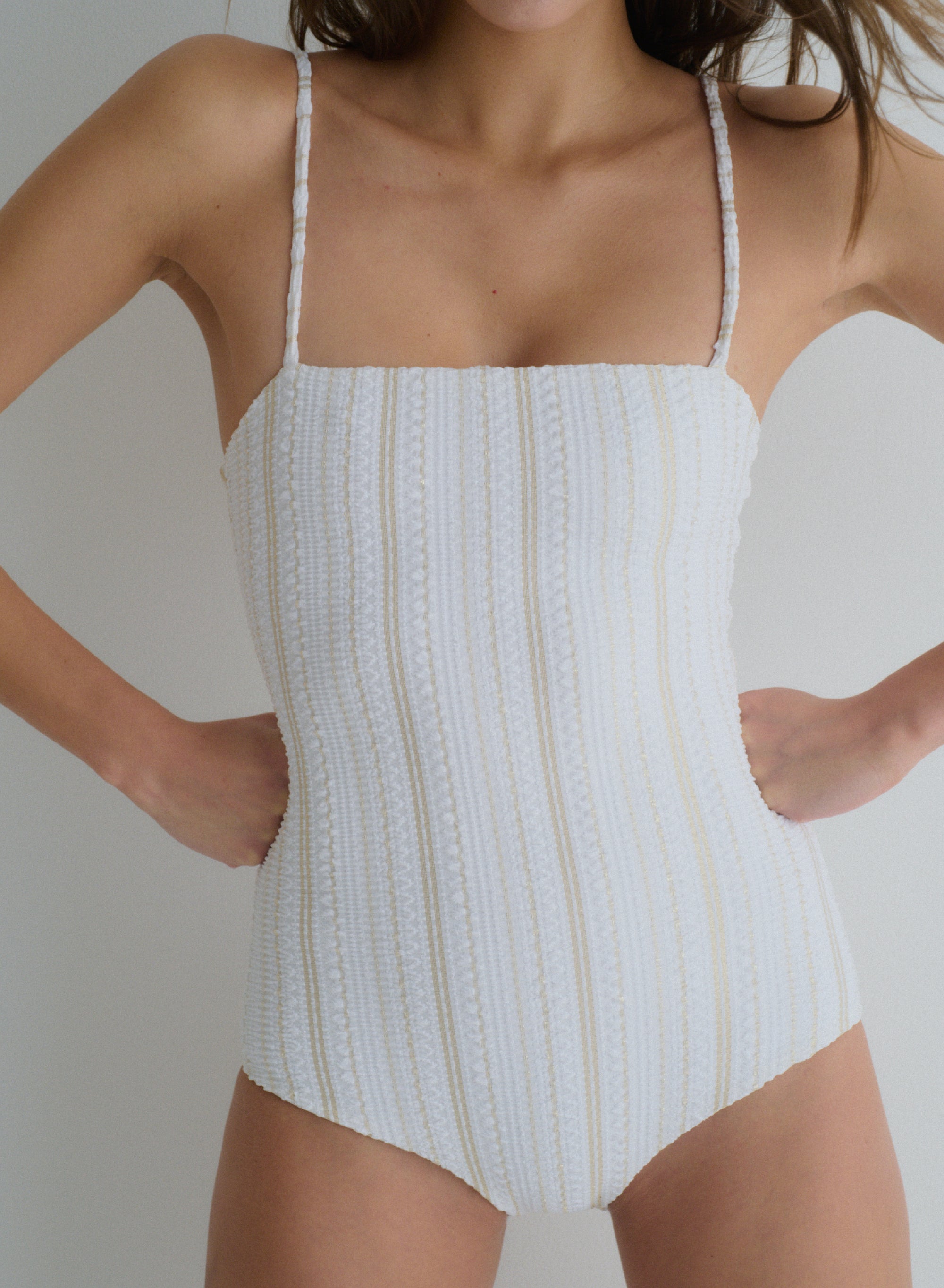 white one-piece swimsuit with thin, shoulder straps in jacquard fabric,  full coverage, front view