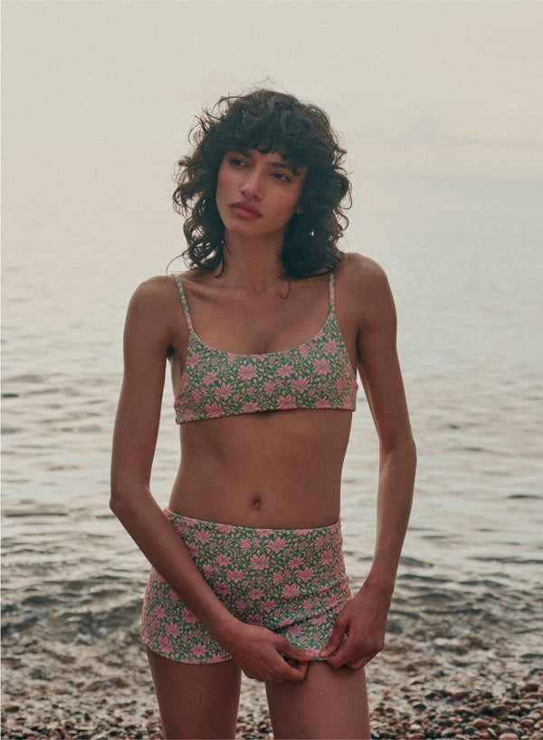 model is wearing green and pink floral bikini bottom swimsuit shorts in jacquard fabric, full coverage 