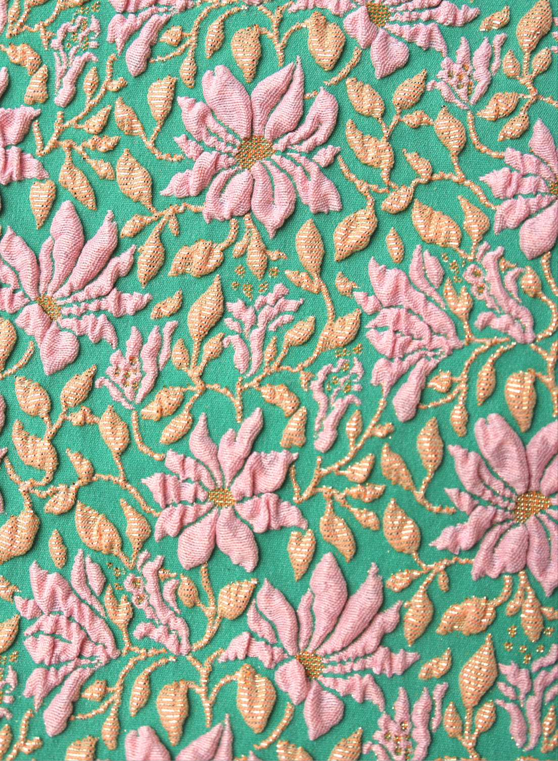 close up of green and pink floral, jacquard swimsuit fabric texture