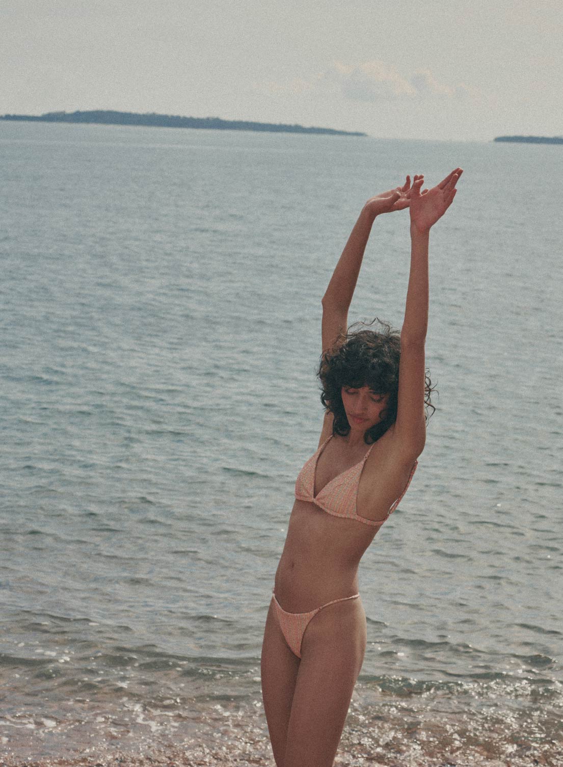 model is wearing orange, multi color  bikini with thin straps in jacquard fabric, front view
