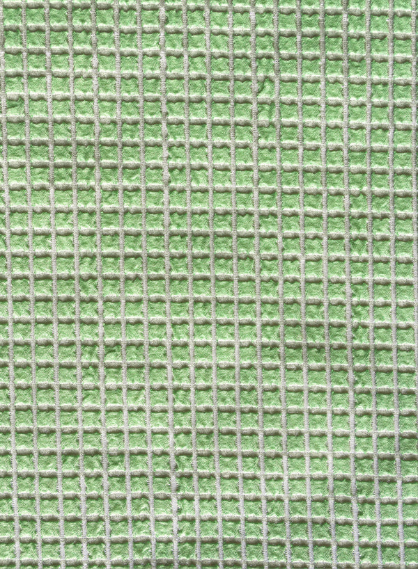 close up of green with white checked jacquard swimsuit fabric texture